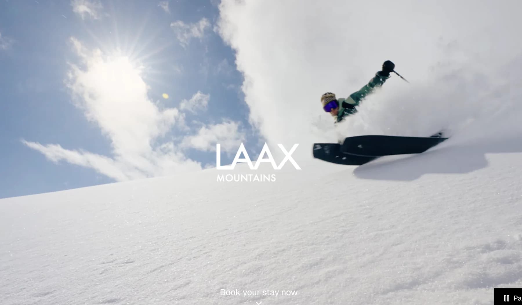 Screenshot of the LAAX resort homepage with a mountain landscape and navigation